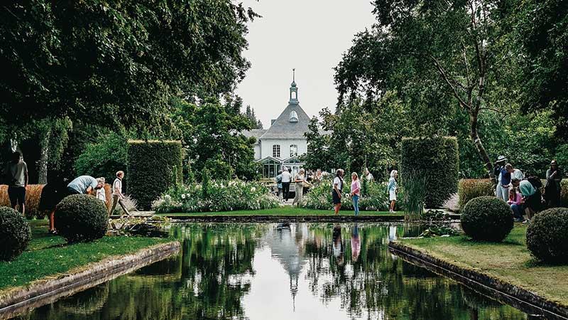 Bes�kare som njuter av Norrvikens tr�dg�rdar i B�stad.